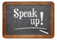 42125354 speak up encouragement motivational text on a vintage slate blackboard