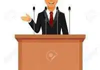 59602307 cartoon businessman or politician in suit at tribune with microphones making a speech orator or narr edumantra.net