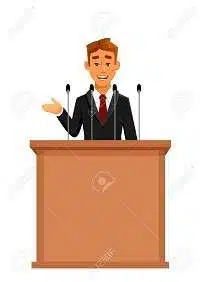 59602307 cartoon businessman or politician in suit at tribune with microphones making a speech orator or narr edumantra.net