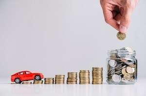 car driving increasing stacked coins near person s hand putting coin glass jar 23 2147919264